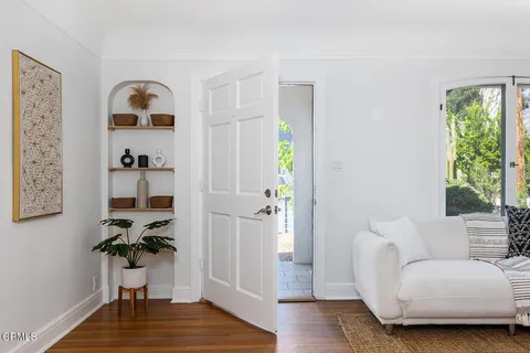 a living room with furniture and a potted plant