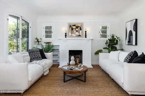 a living room with furniture and a fireplace