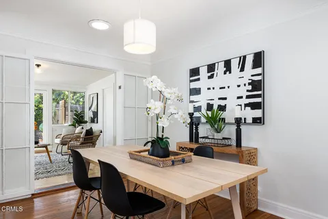 a view of a dining room with furniture and wooden floor