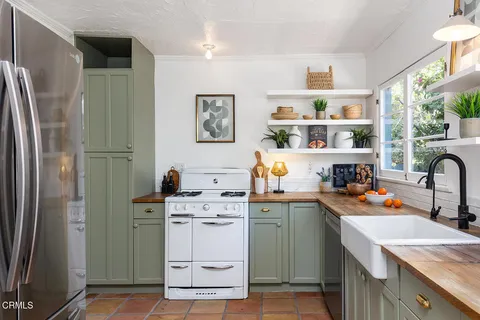 a room with a refrigerator and a sink