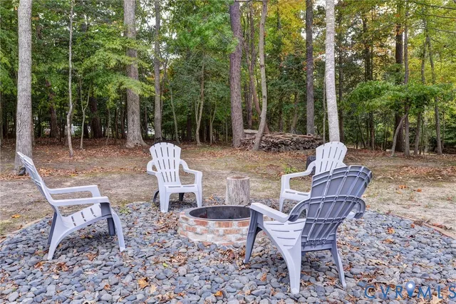 a view of a chairs and table in backyard