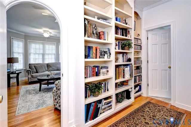 a living room with lots of furniture and a book shelf