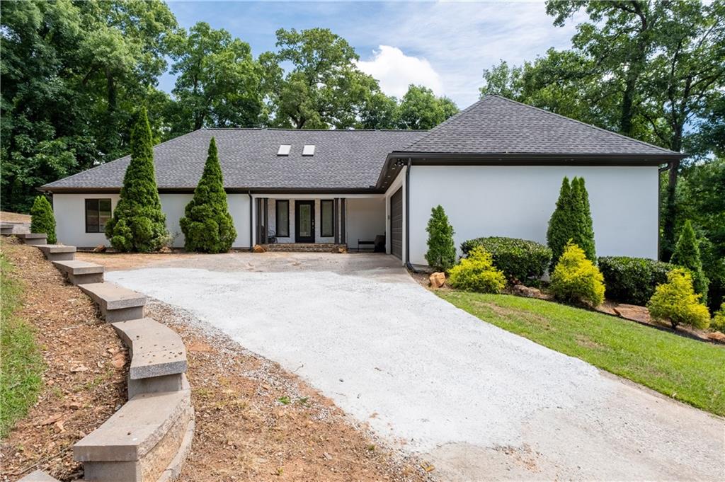 4610 West Morton Road Alpharetta, GA 30022 - Photo 2 of 53 a front view of a house with a yard and garage