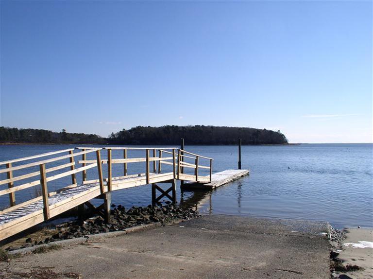 20 Jackbon Road Mashpee, MA 02649 - Photo 25 of 26 a view of a roof deck with table and chairs under an umbrella