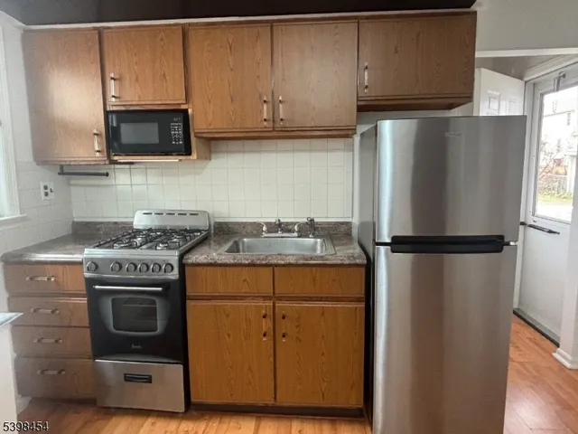 a kitchen with a refrigerator sink and microwave