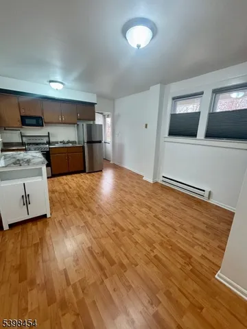 a view of a kitchen with microwave and cabinets