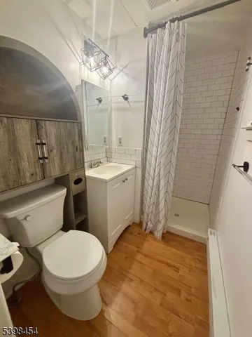 a bathroom with a toilet a sink and shower