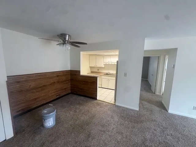 a view of an empty room with a dresser