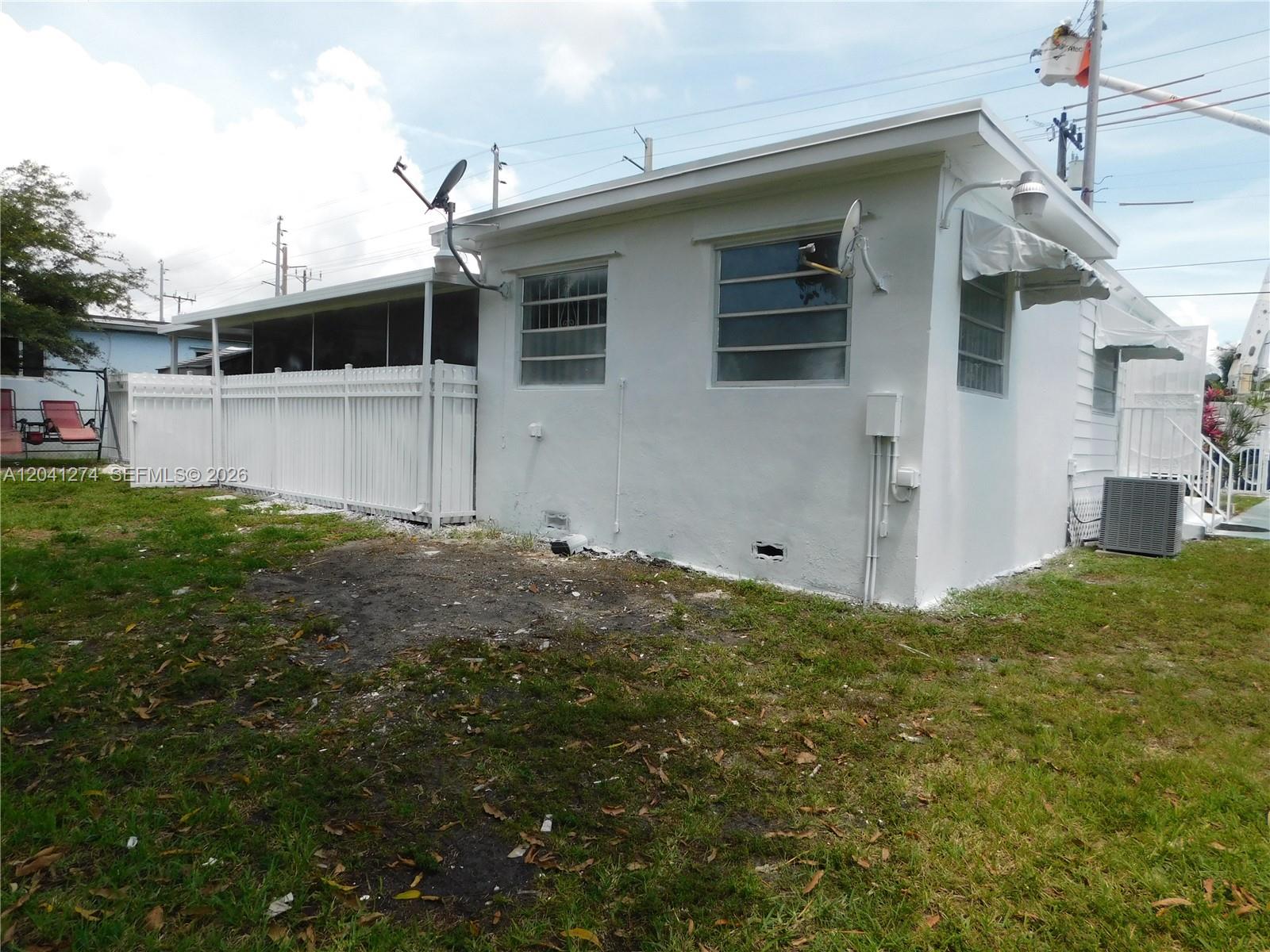 2230 Northwest 58th Street, Unit B Miami, FL 33142 - Photo 3 of 18 a view of a house with backyard