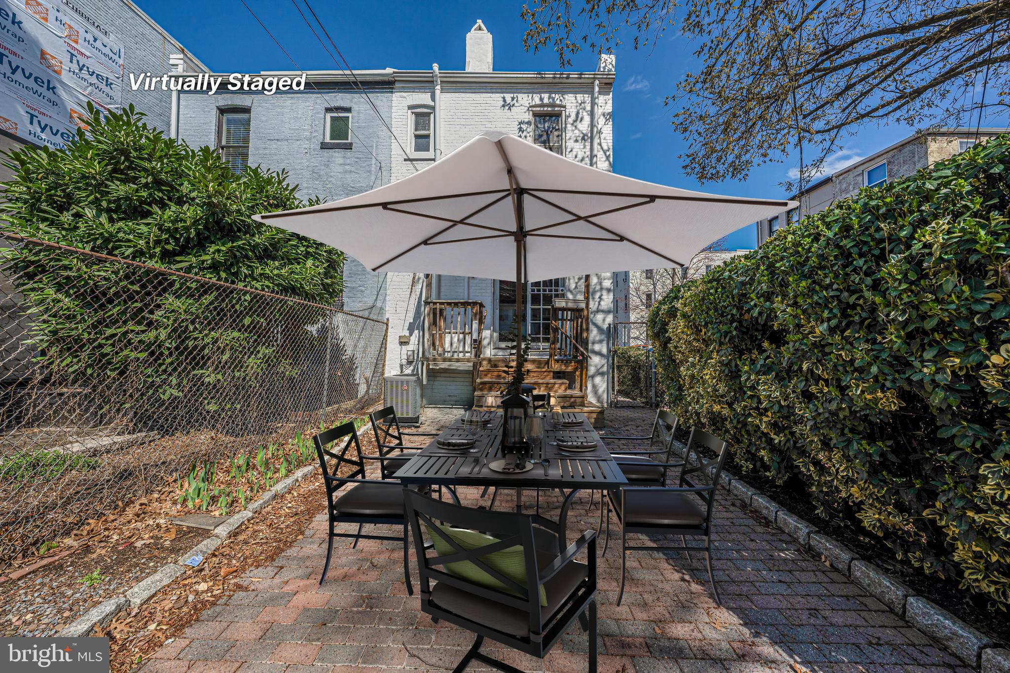 1502 Caroline Street Northwest Washington, DC 20009 - Photo 19 of 22 a view of a patio with table and chairs under an umbrella