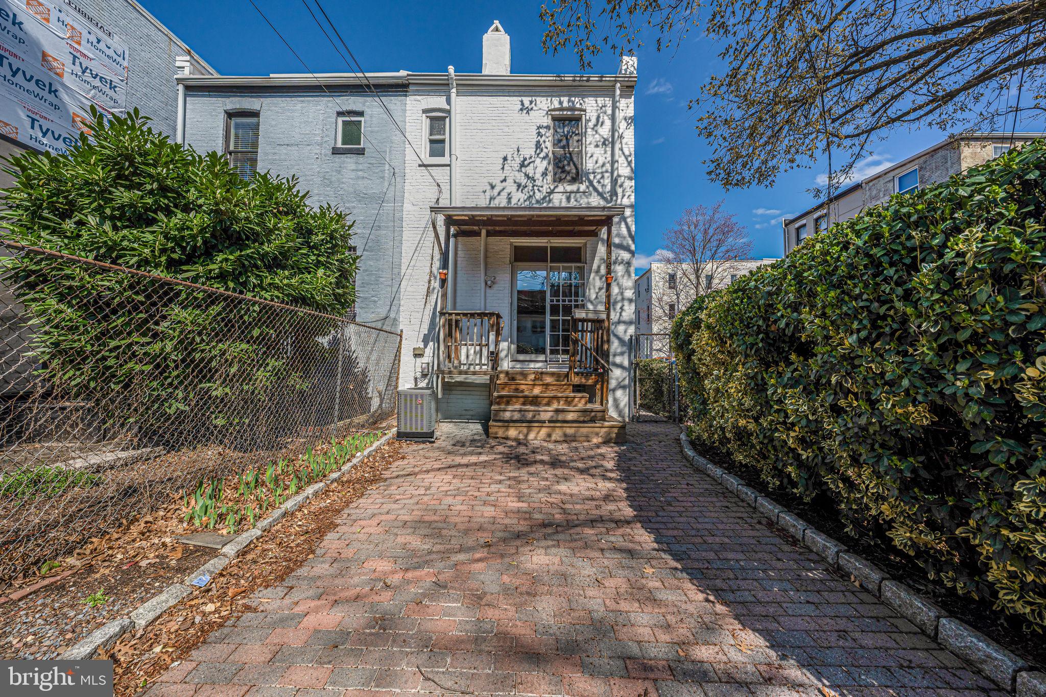 1502 Caroline Street Northwest Washington, DC 20009 - Photo 20 of 22 a view of house with patio outdoor seating and yard