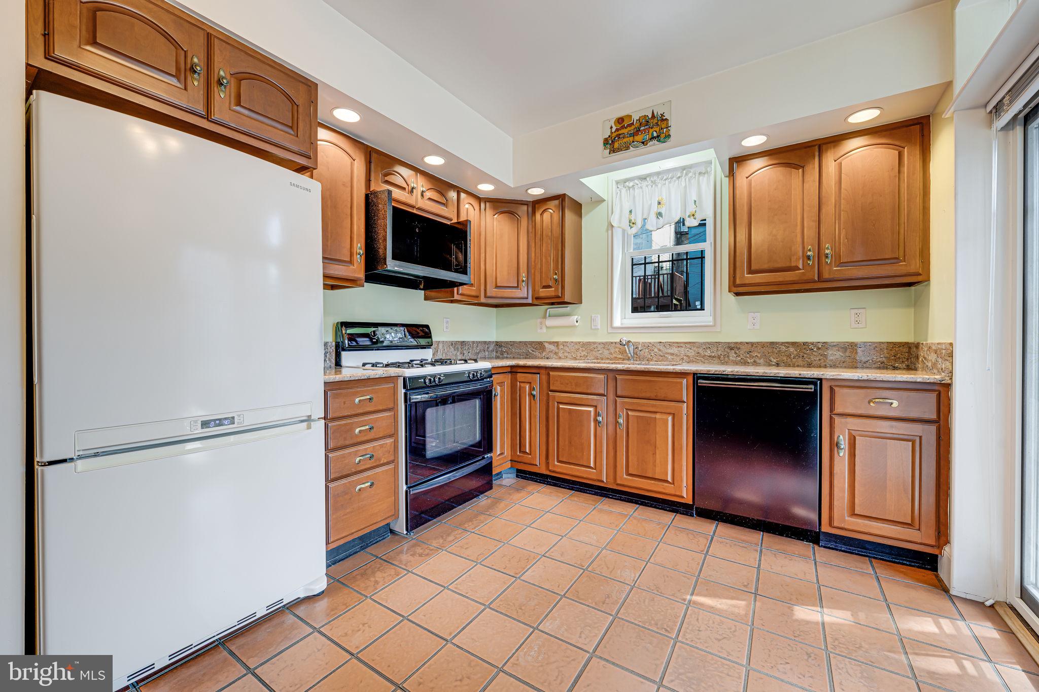 1502 Caroline Street Northwest Washington, DC 20009 - Photo 8 of 22 a kitchen with stainless steel appliances granite countertop a stove top oven a sink and dishwasher