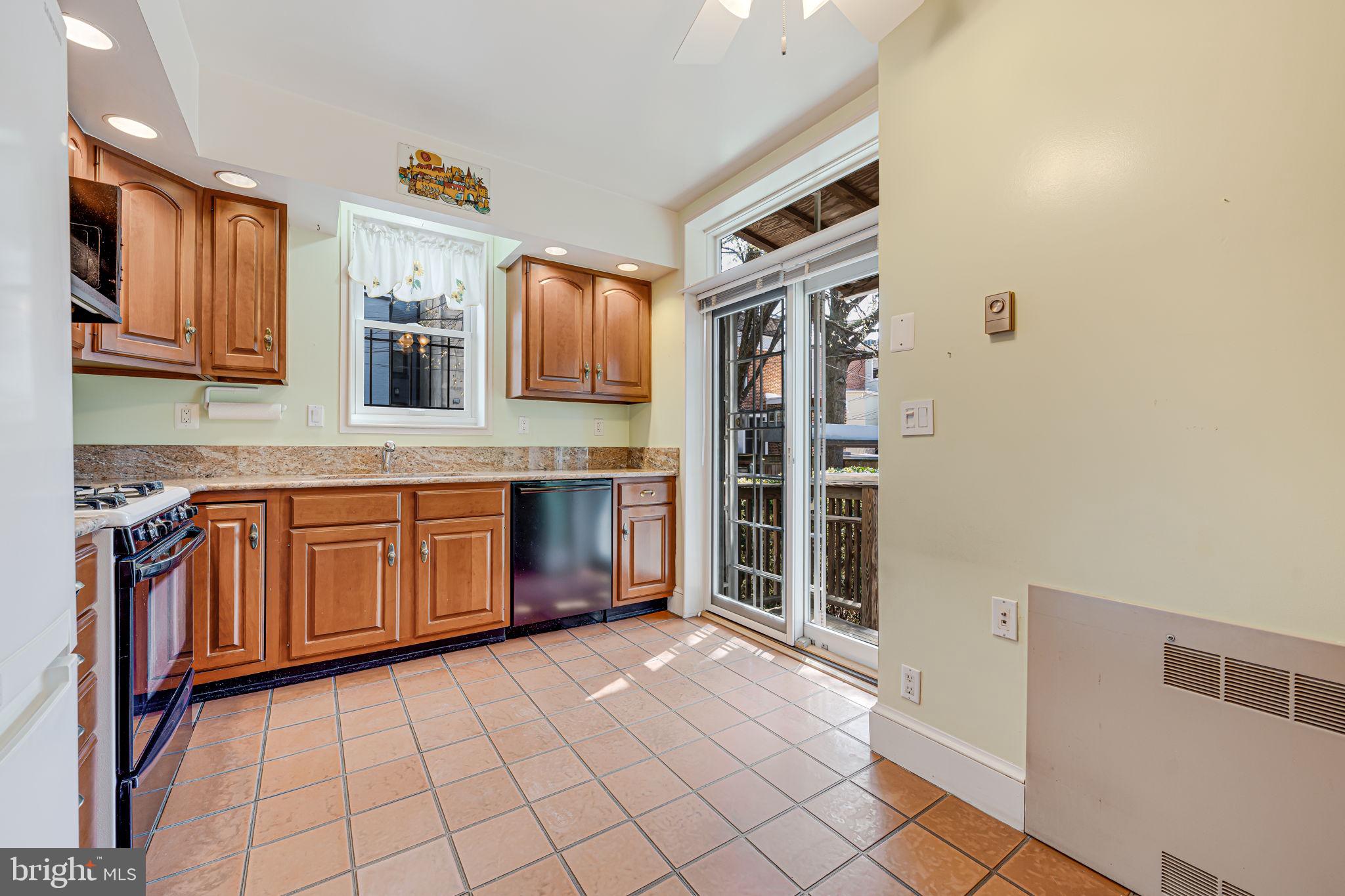 1502 Caroline Street Northwest Washington, DC 20009 - Photo 9 of 22 a kitchen with stainless steel appliances granite countertop a stove a sink and a refrigerator