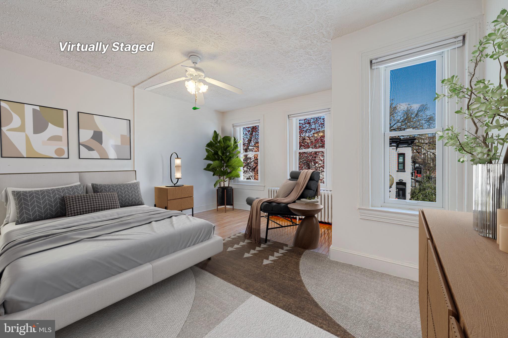 1502 Caroline Street Northwest Washington, DC 20009 - Photo 10 of 22 a bedroom with furniture and a chandelier