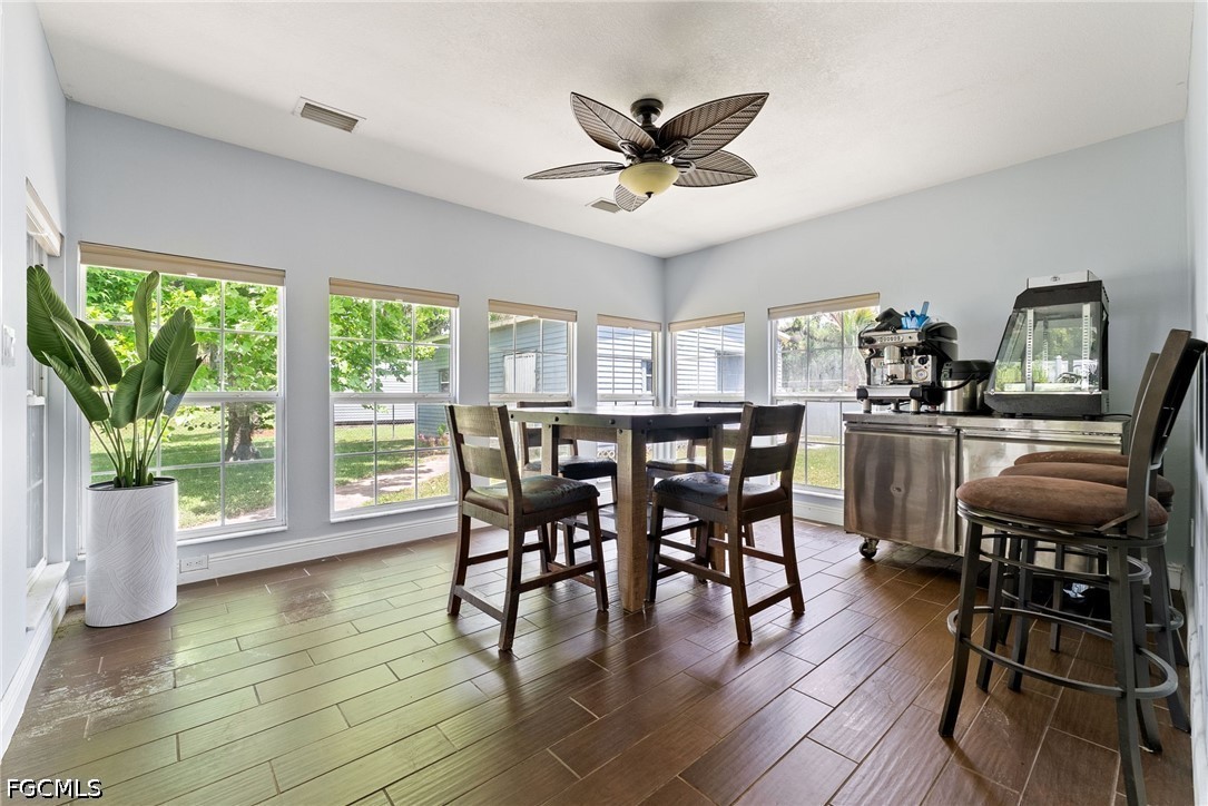 17290 Rewis Road Alva, FL 33920 - Photo 13 of 50 a view of a dining room with furniture window and wooden floor