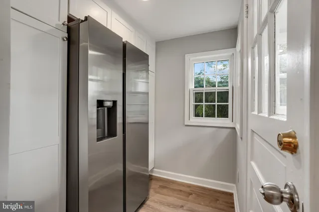 a view of kitchen with stainless steel appliances refrigerator and window