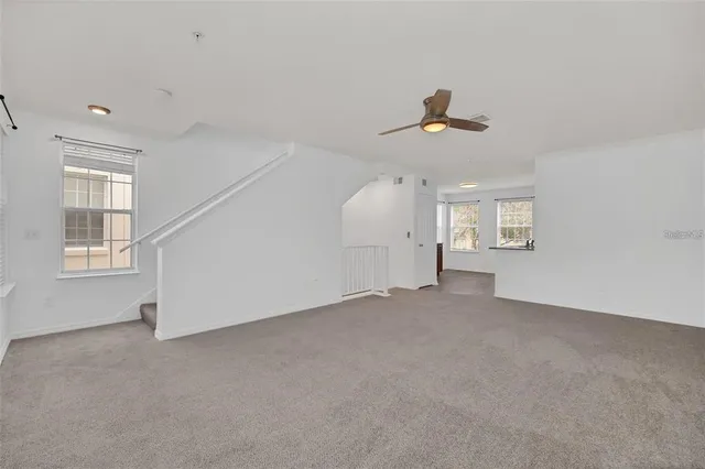 an empty room with a empty space and windows