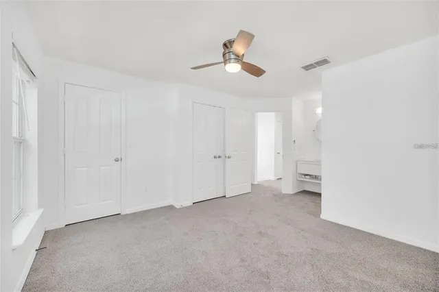 a spacious bathroom with a tub sink and mirror