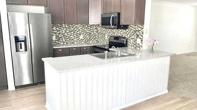 a view of kitchen with wooden floor and windows