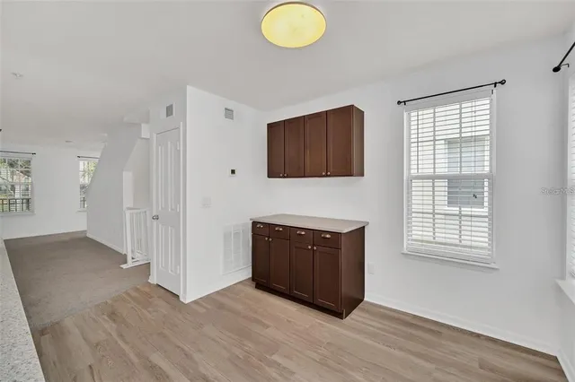 a view with granite countertop a sink and a refrigerator
