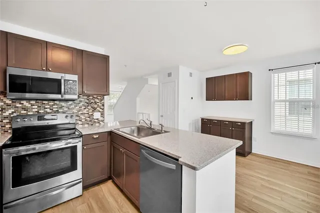 a view of a swimming pool with a patio and a yard