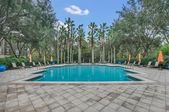 a view of a brick house with windows and plants
