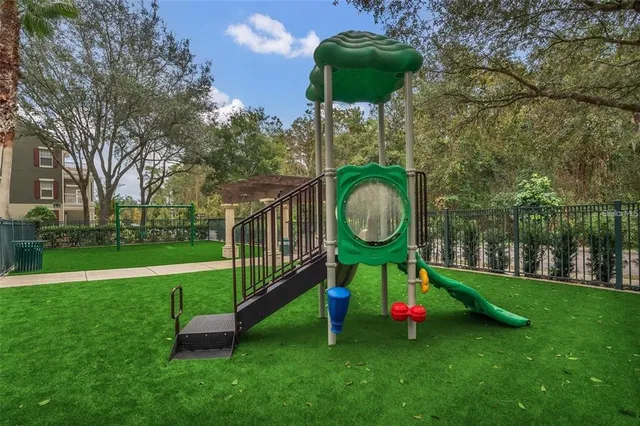 a view of a house with backyard and a tree