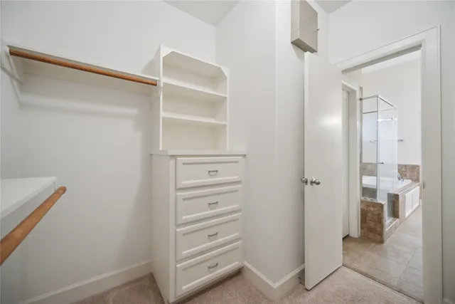 a view of walk in closet with empty racks