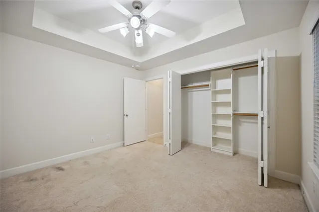 a view of an empty room with a ceiling fan