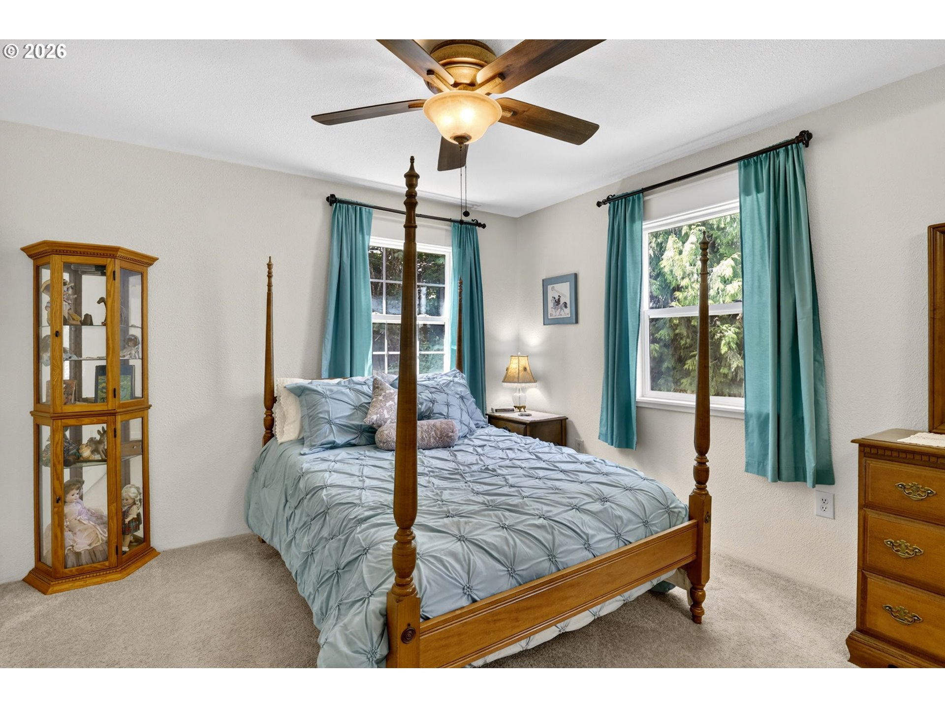 33951 Southeast Coupland Road Estacada, OR 97023 - Photo 12 of 48 a bedroom with a large bed and a chandelier