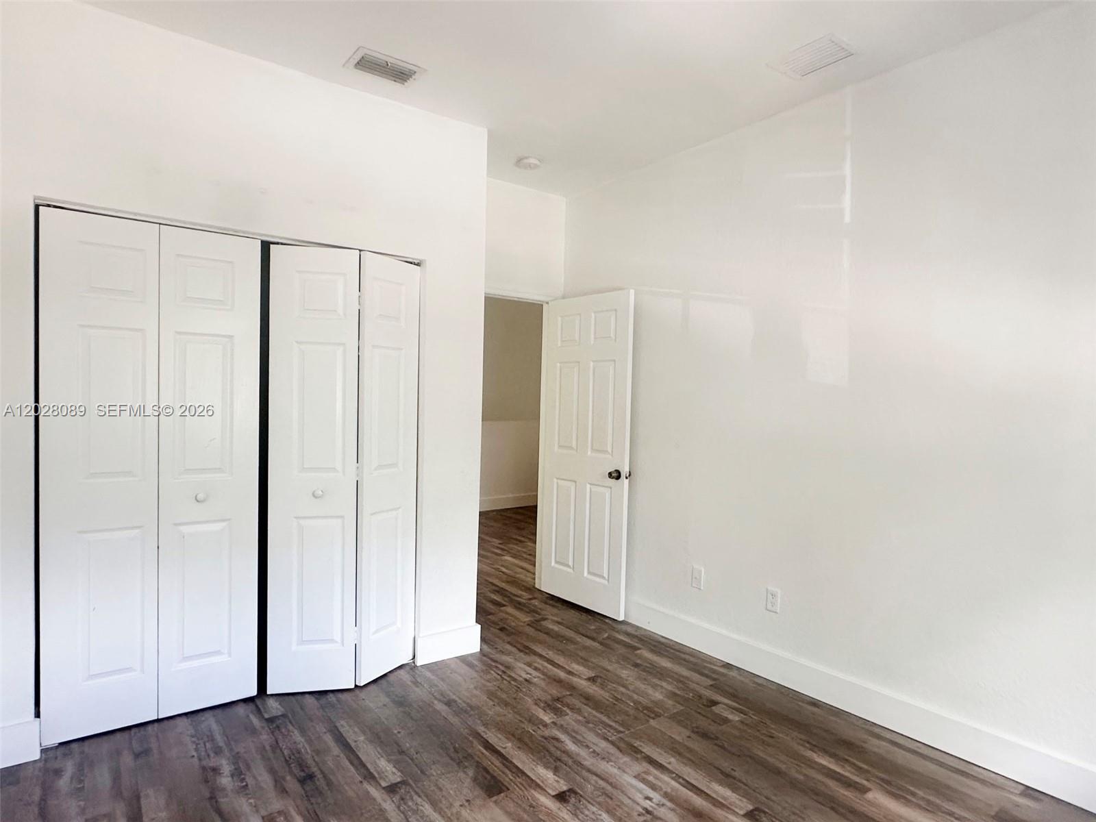 662 Northeast 21st Terrace Homestead, FL 33033 - Photo 21 of 34 a view of an empty room with wooden floor