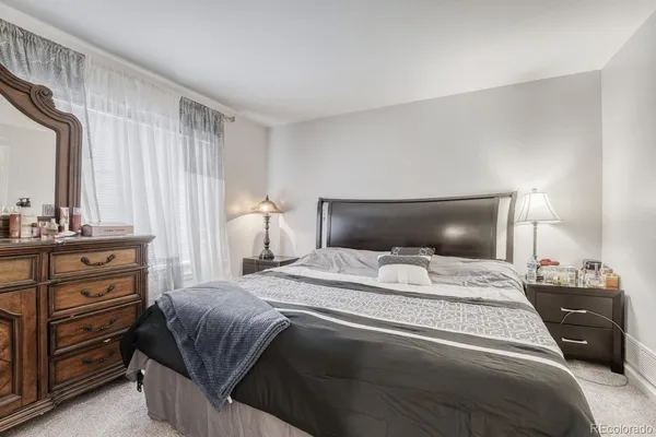 a bedroom with a bed and dresser