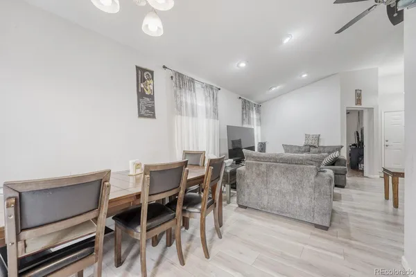 a kitchen with stainless steel appliances kitchen island granite countertop a dining table chairs and granite counter tops