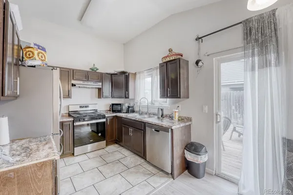 a kitchen with a sink stove and refrigerator