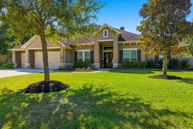 a front view of a house with swimming pool and garden