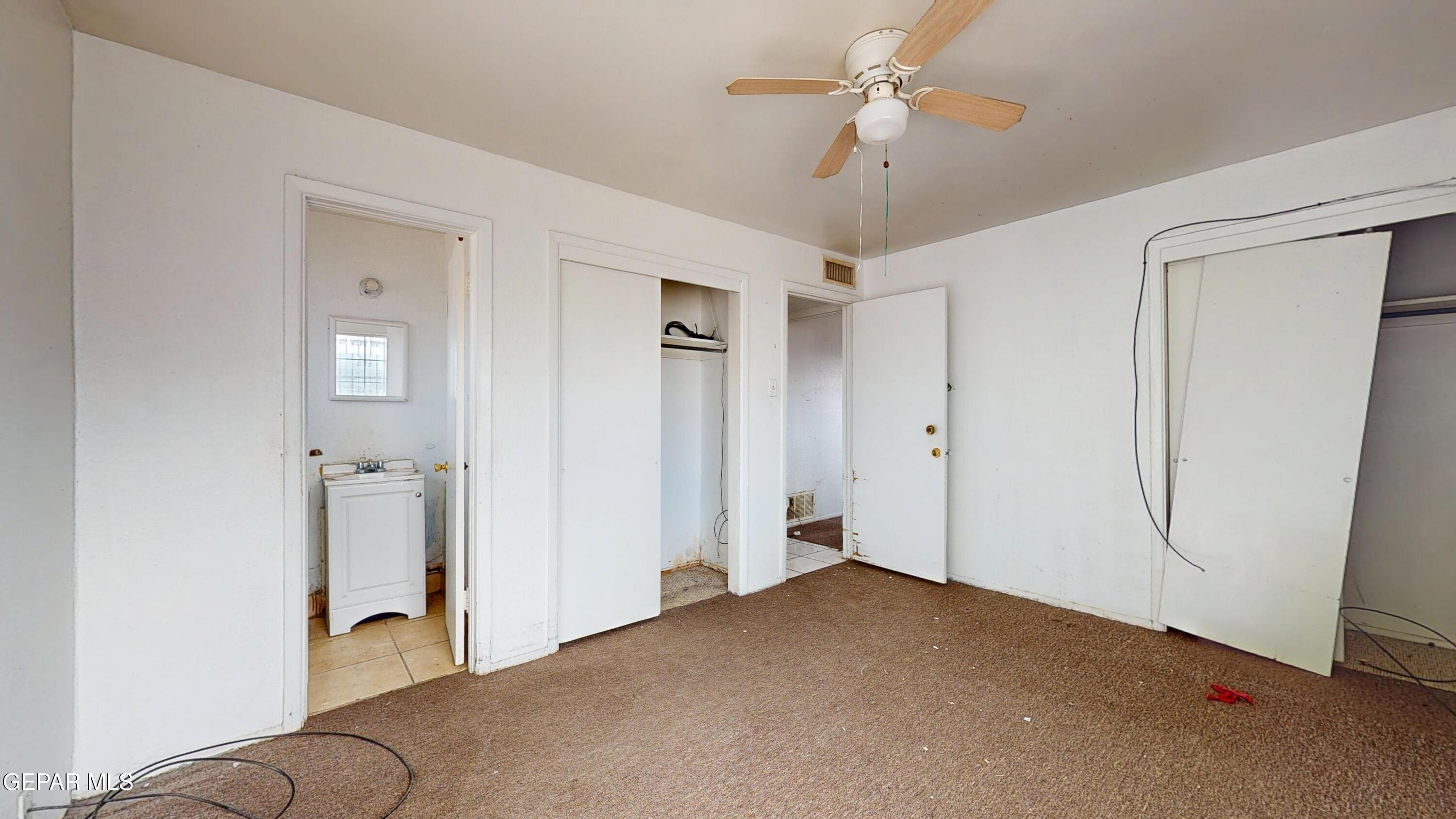 135 Baywood Road El Paso, TX 79915 - Photo 17 of 43 a livingroom with a chandelier fan and closet