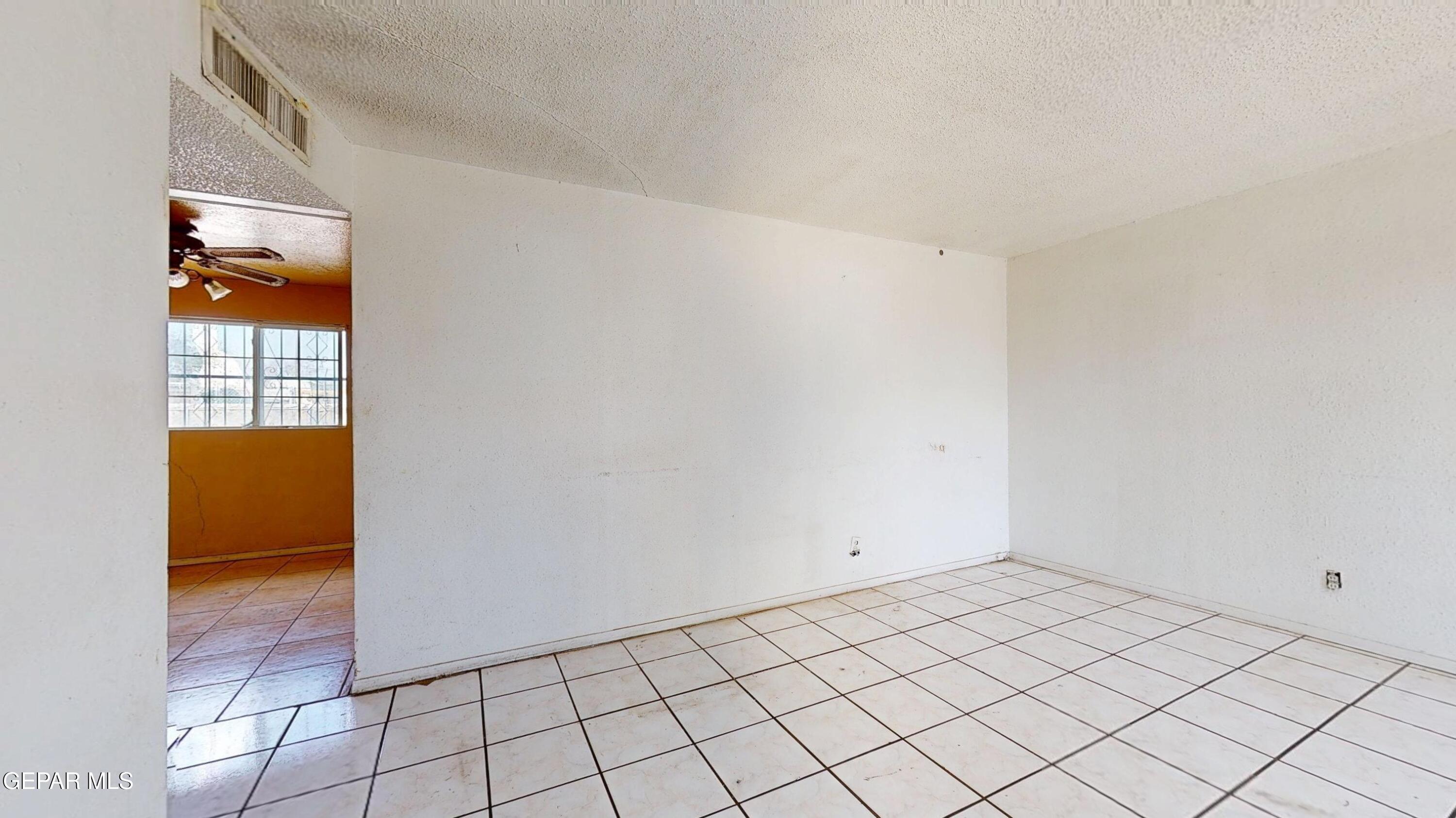 135 Baywood Road El Paso, TX 79915 - Photo 2 of 43 a view of an empty room and wooden floor