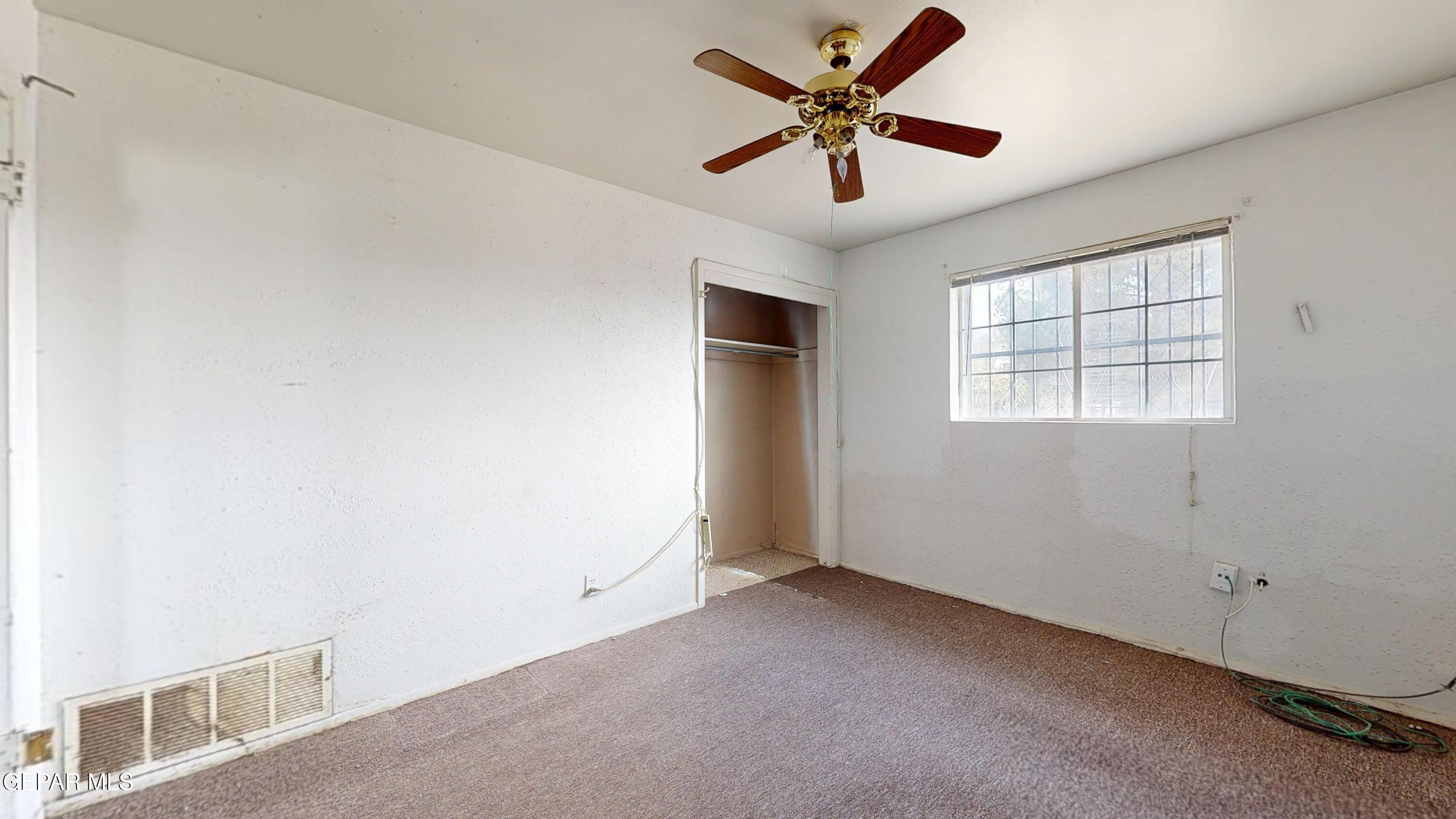 135 Baywood Road El Paso, TX 79915 - Photo 21 of 43 an empty room with a window and a fan