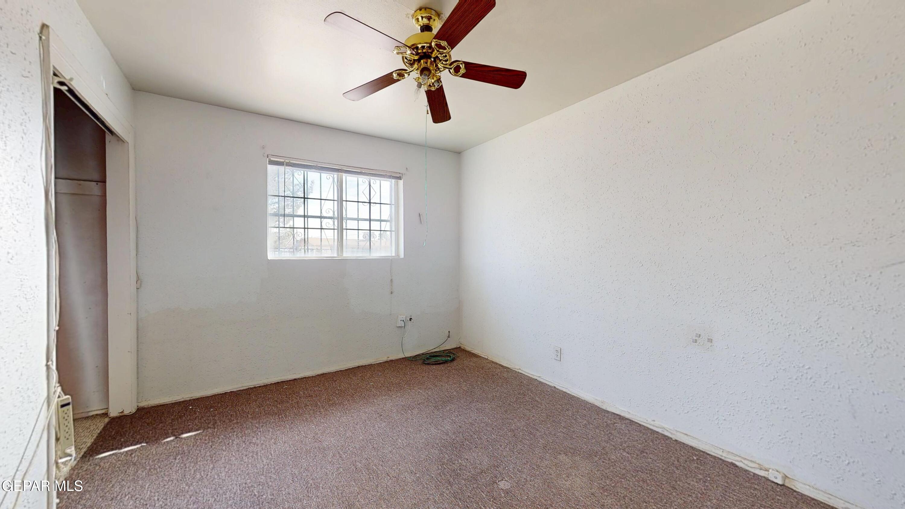 135 Baywood Road El Paso, TX 79915 - Photo 27 of 43 an empty room with windows and a ceiling fan