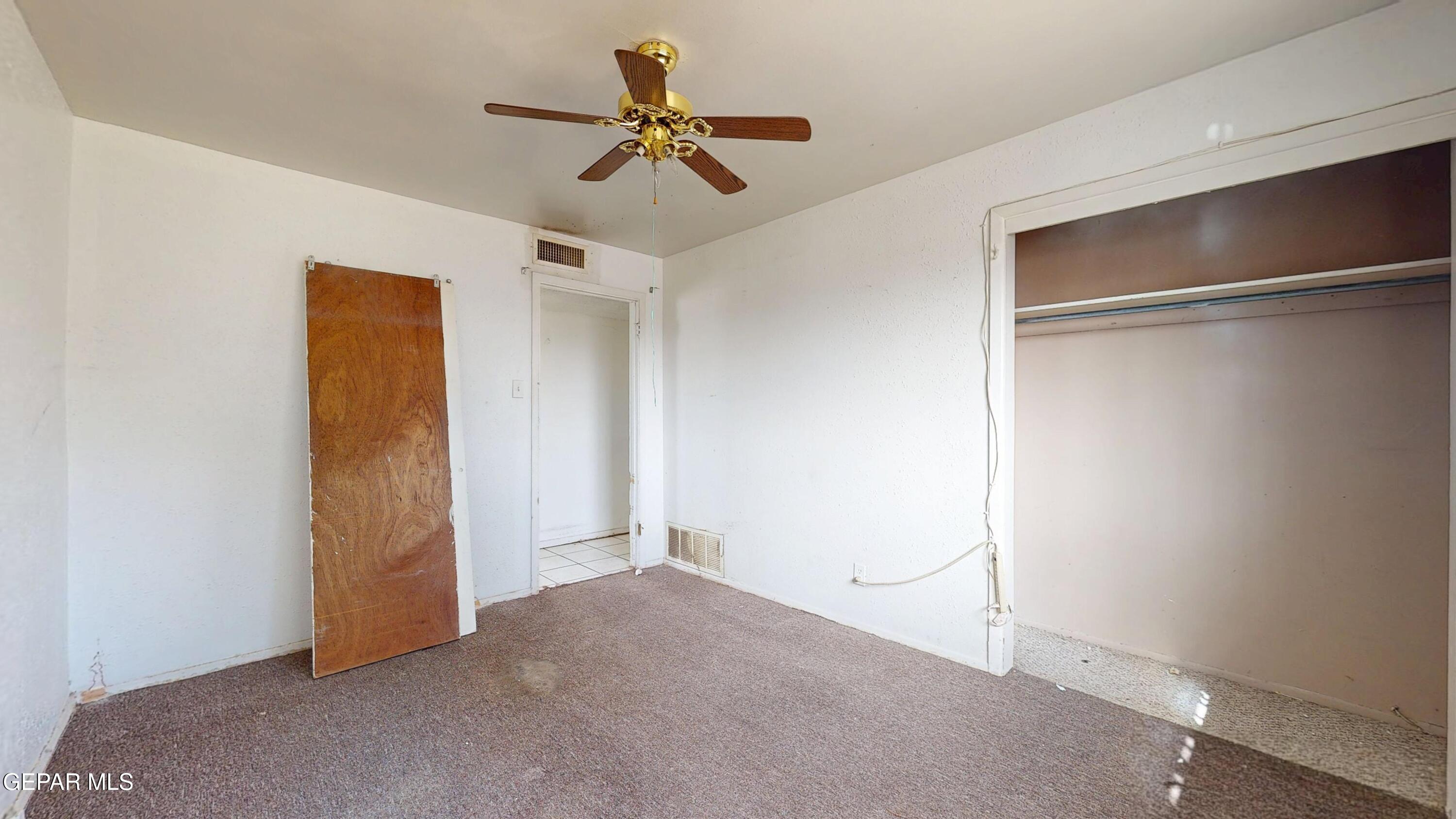 135 Baywood Road El Paso, TX 79915 - Photo 29 of 43 a view of a livingroom with a ceiling fan and wooden floor