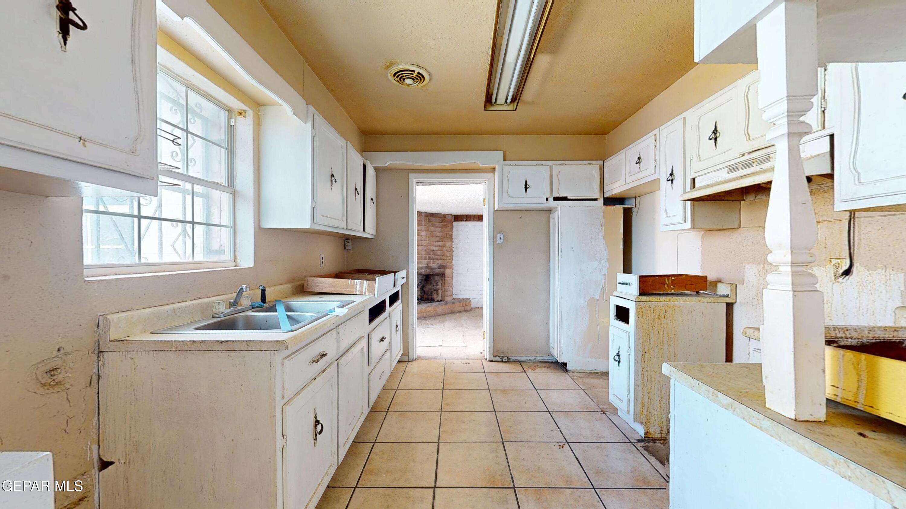 135 Baywood Road El Paso, TX 79915 - Photo 9 of 43 a kitchen with a sink stove and refrigerator