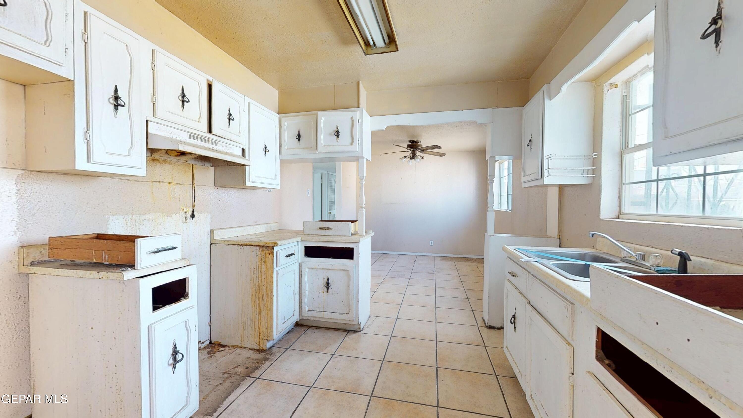 135 Baywood Road El Paso, TX 79915 - Photo 10 of 43 a kitchen with granite countertop a sink stove and refrigerator