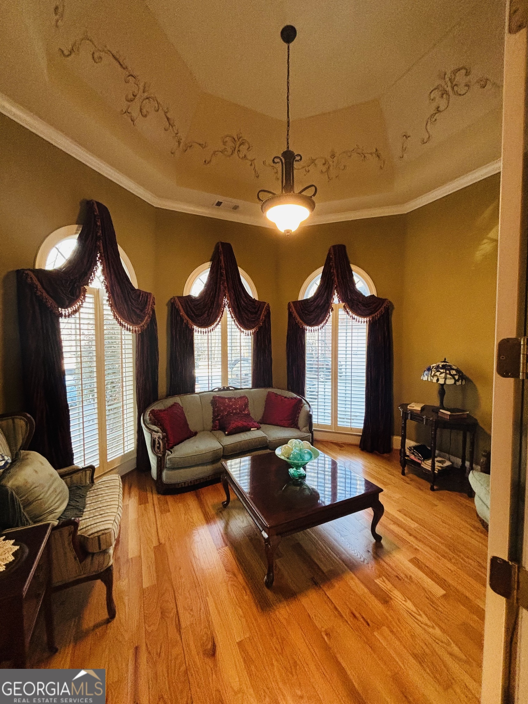 74 Waterford Path Hiram, GA 30141 - Photo 28 of 43 a living room with furniture and a chandelier