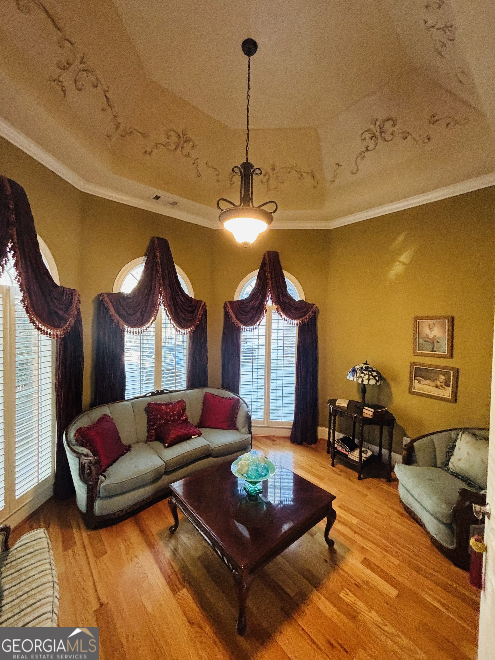 74 Waterford Path Hiram, GA 30141 - Photo 29 of 43 a living room with furniture a chandelier and a fireplace