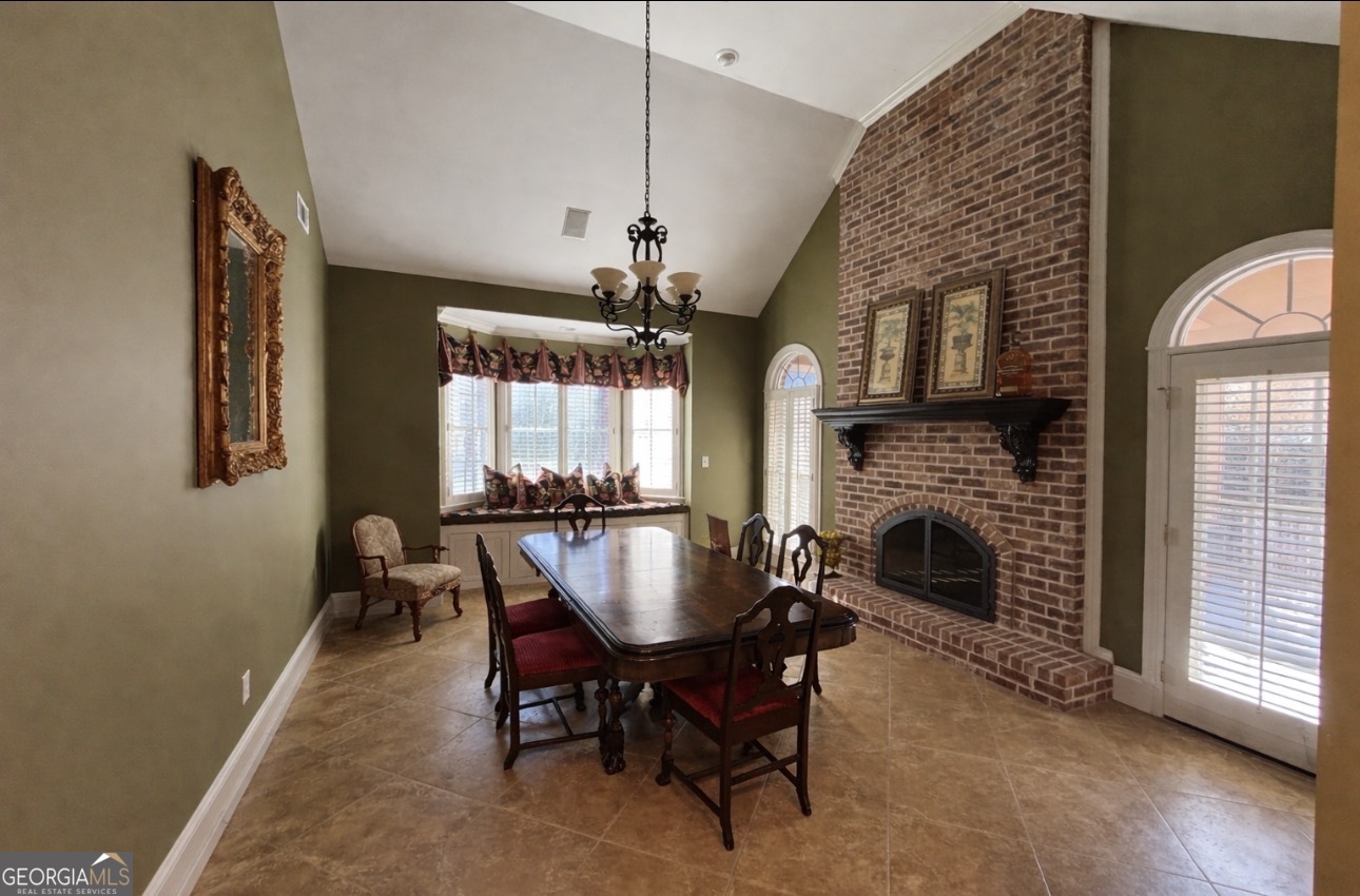 74 Waterford Path Hiram, GA 30141 - Photo 33 of 43 a dining room with furniture a fireplace and wooden floor