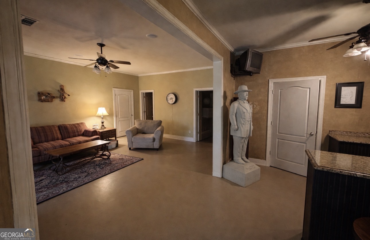 74 Waterford Path Hiram, GA 30141 - Photo 35 of 43 a living room with furniture a ceiling fan and a rug