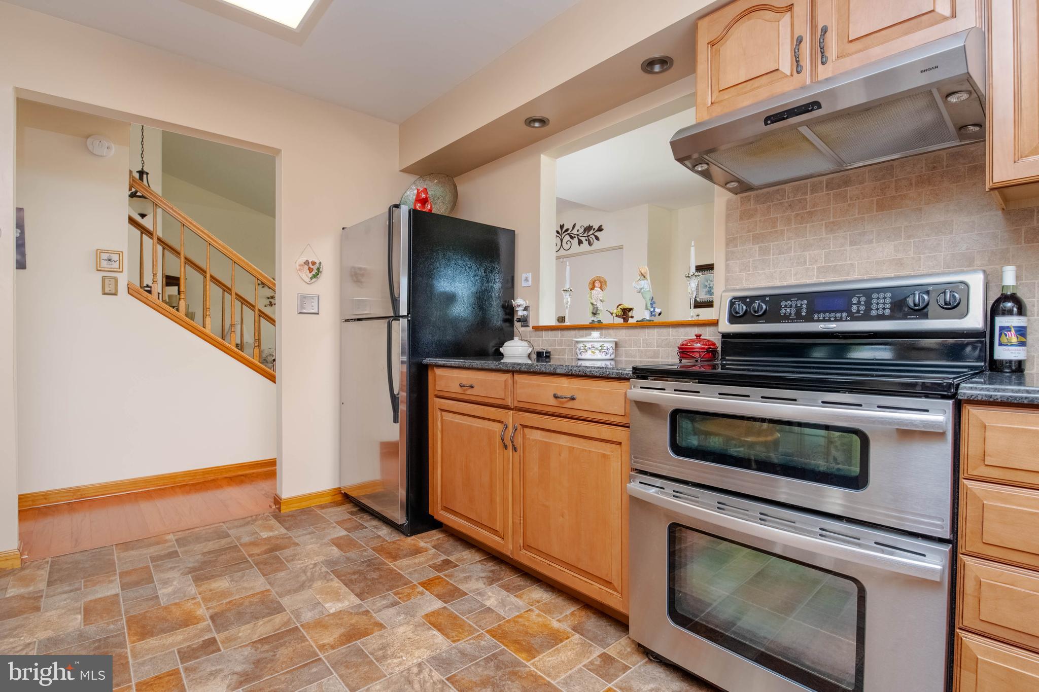 110 Shell Cove Court Joppa, MD 21085 - Photo 18 of 104 a kitchen with stainless steel appliances granite countertop a stove a sink and a refrigerator