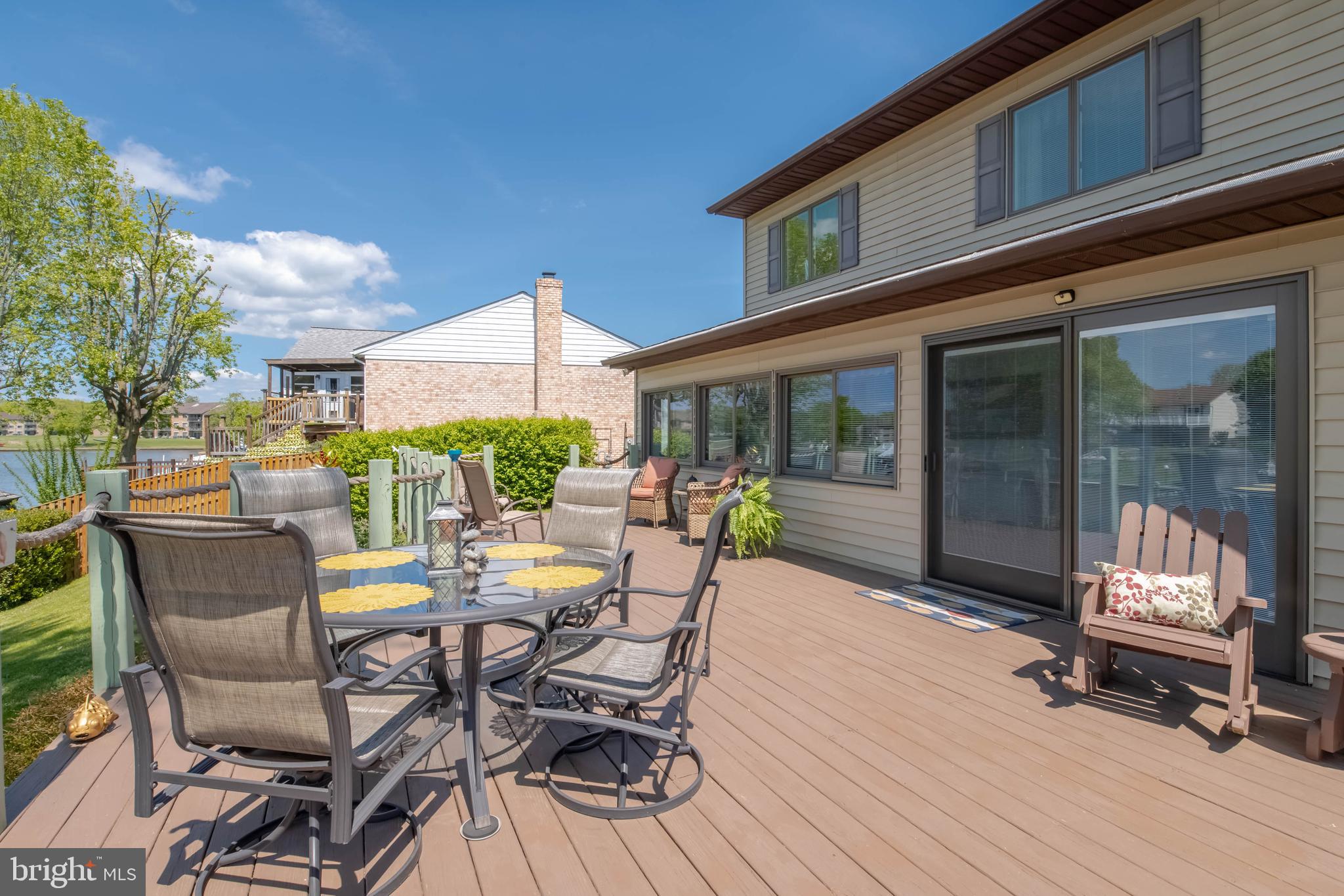 110 Shell Cove Court Joppa, MD 21085 - Photo 34 of 104 a view of a patio with a dining table and chairs with wooden floor and fence