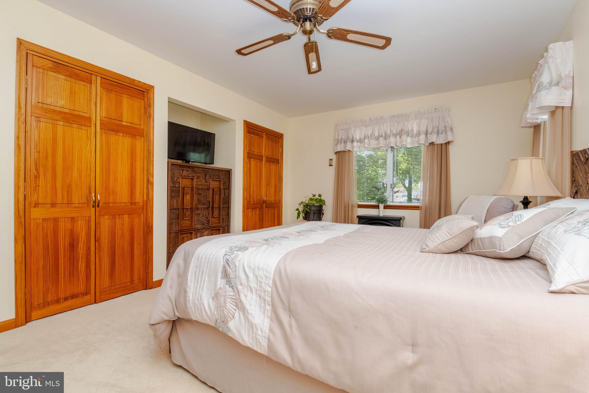 110 Shell Cove Court Joppa, MD 21085 - Photo 69 of 104 a bedroom with a bed and a chandelier