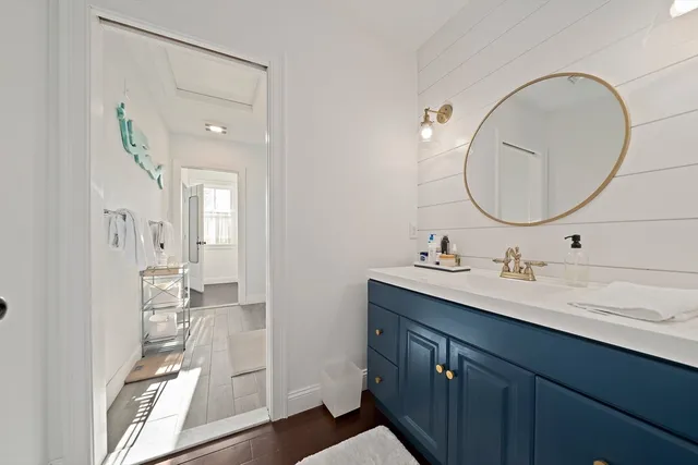 a bathroom with a double vanity sink and a mirror